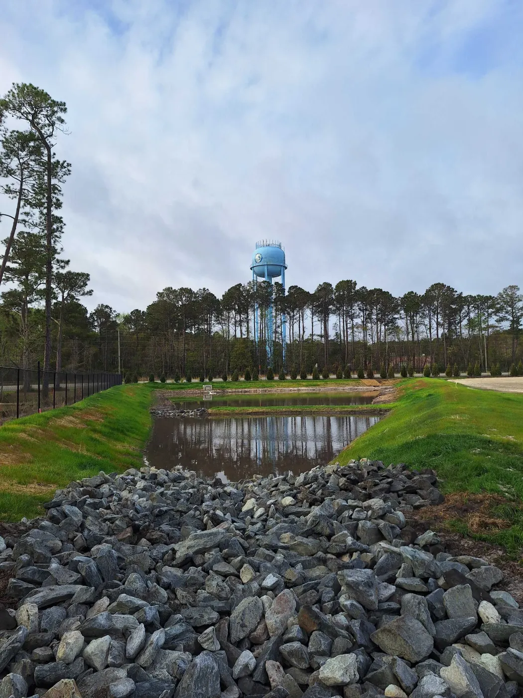 Pond bank armored with rip-rap by the water tower