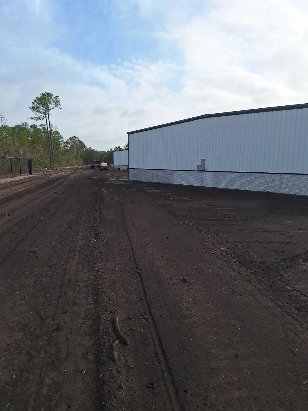 Site work running alongside a metal building