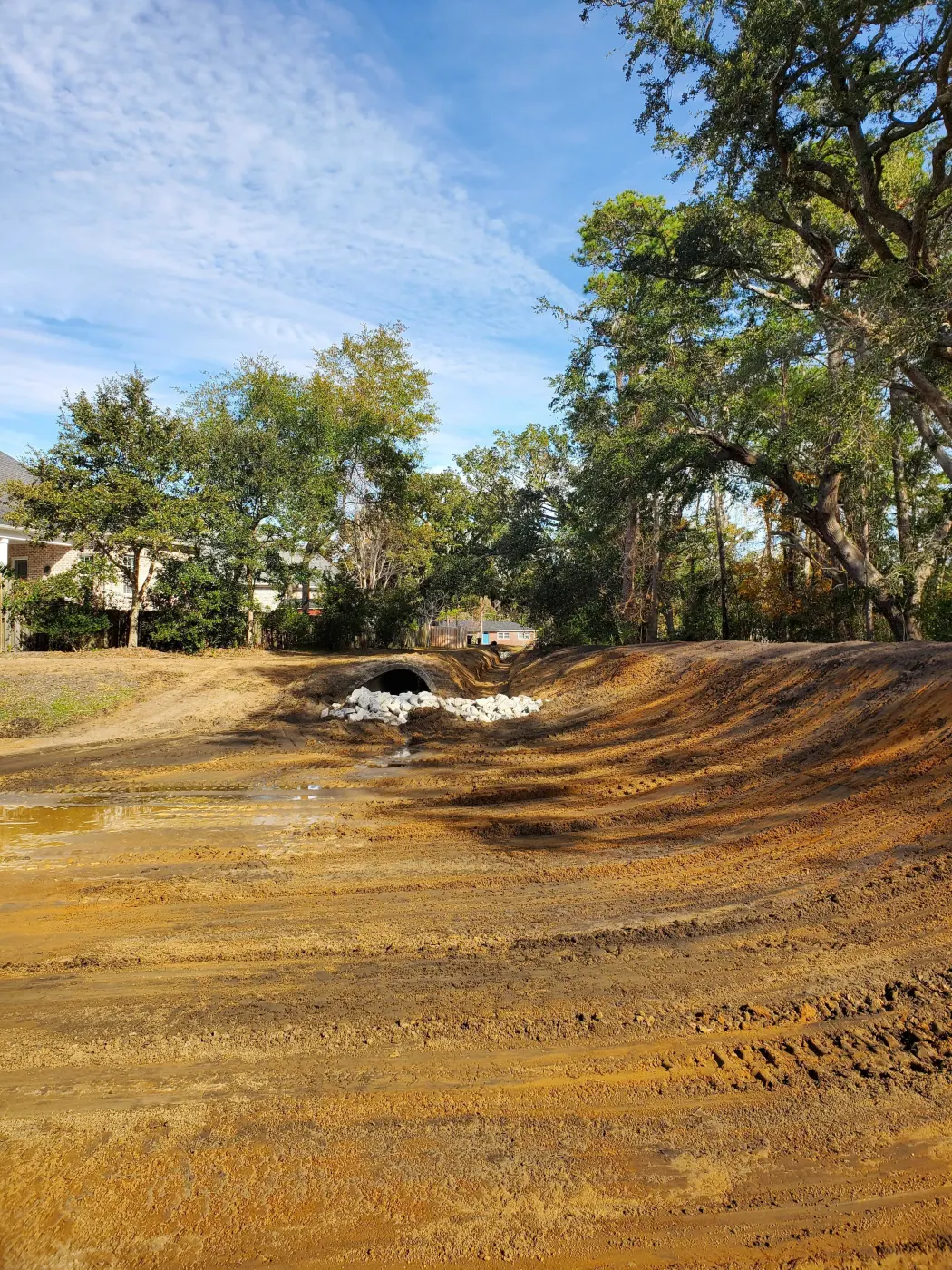 Drainage swale shaped through a work area