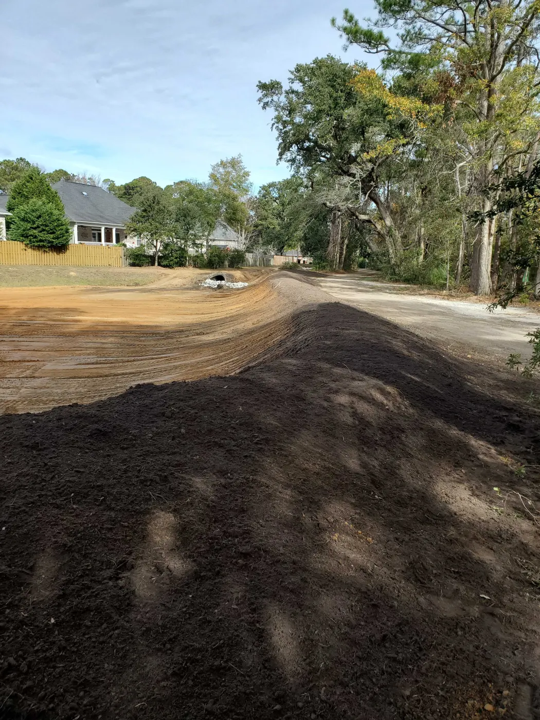 Gravel driveway installation finished and crowned after driveway grading in Pender County, NC